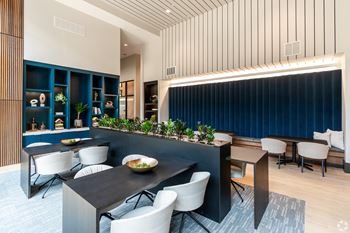 A modern dining area with a long table and chairs.